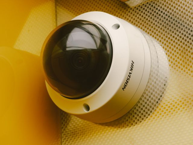 A dome CCTV camera mounted on a ceiling
